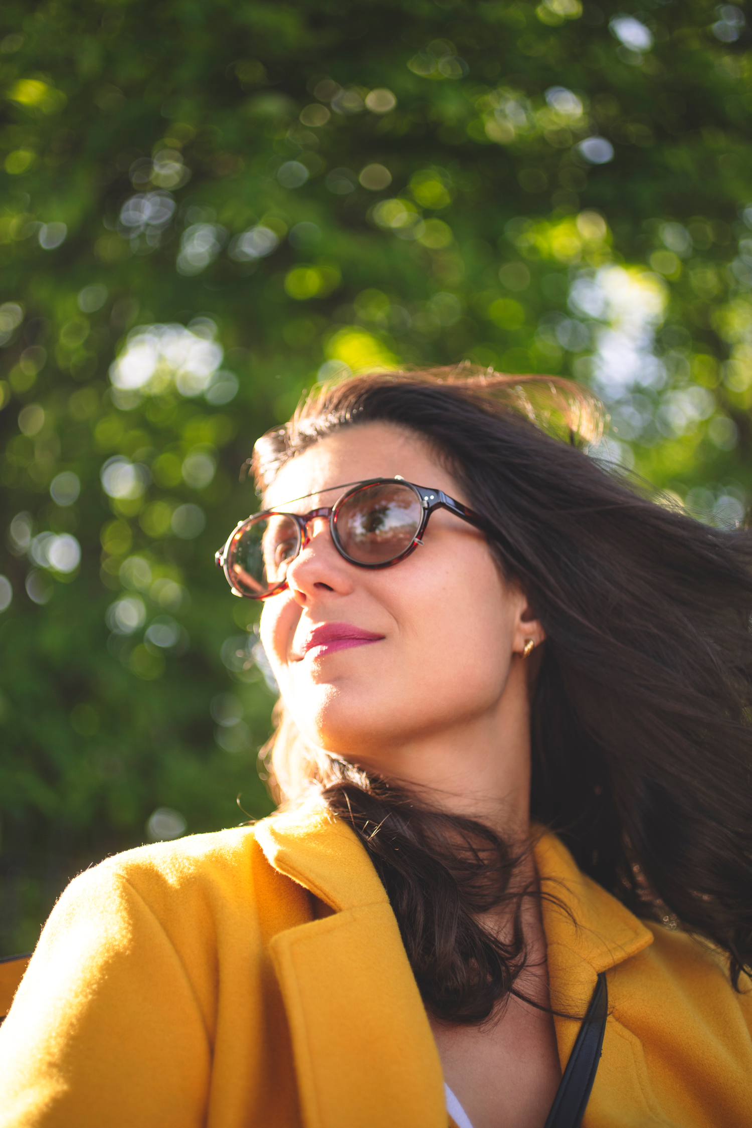 Woman wearing Avulux bli with clip-on migraine glasses with wind in her hair