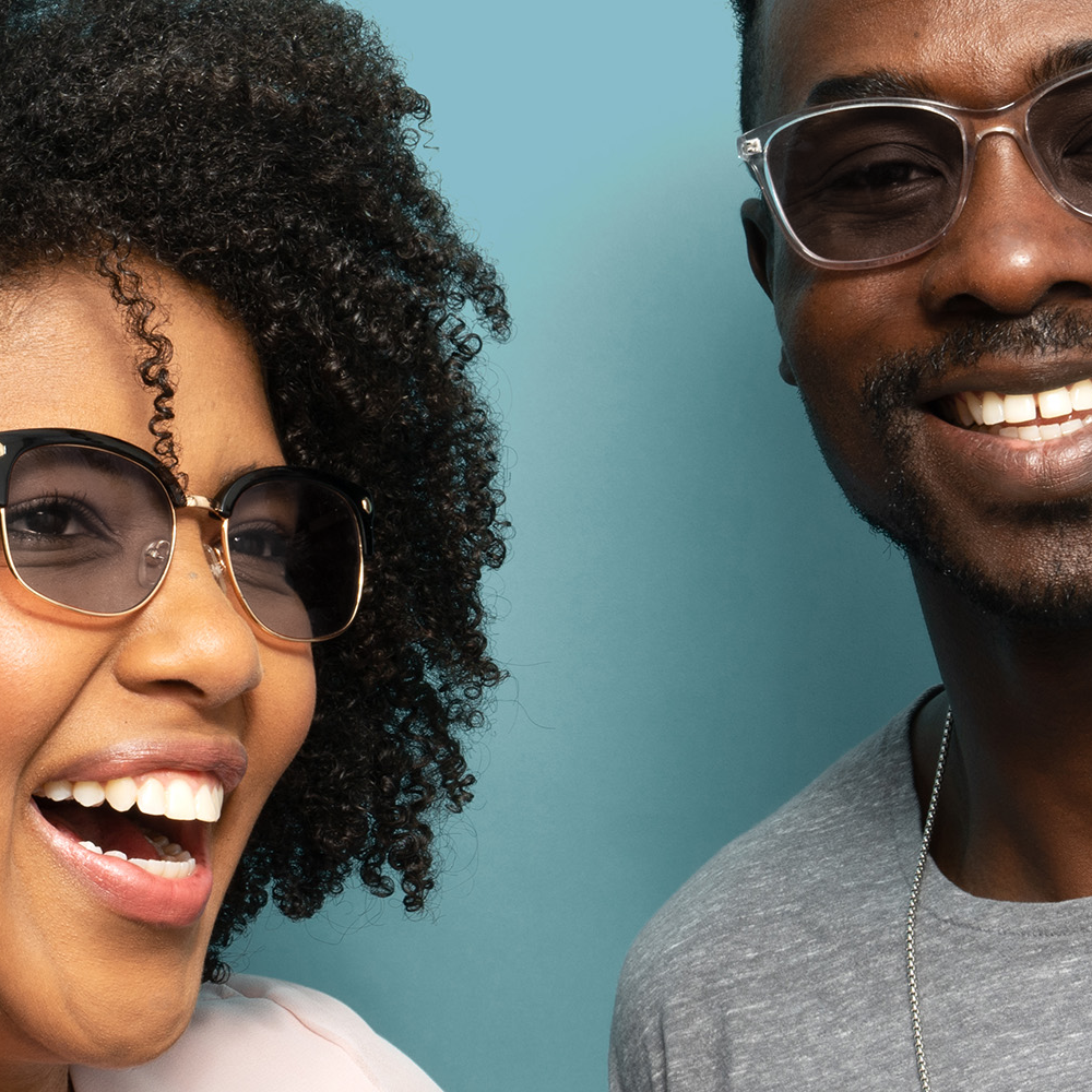 Happy man and woman wearing axon optics migraine glasses