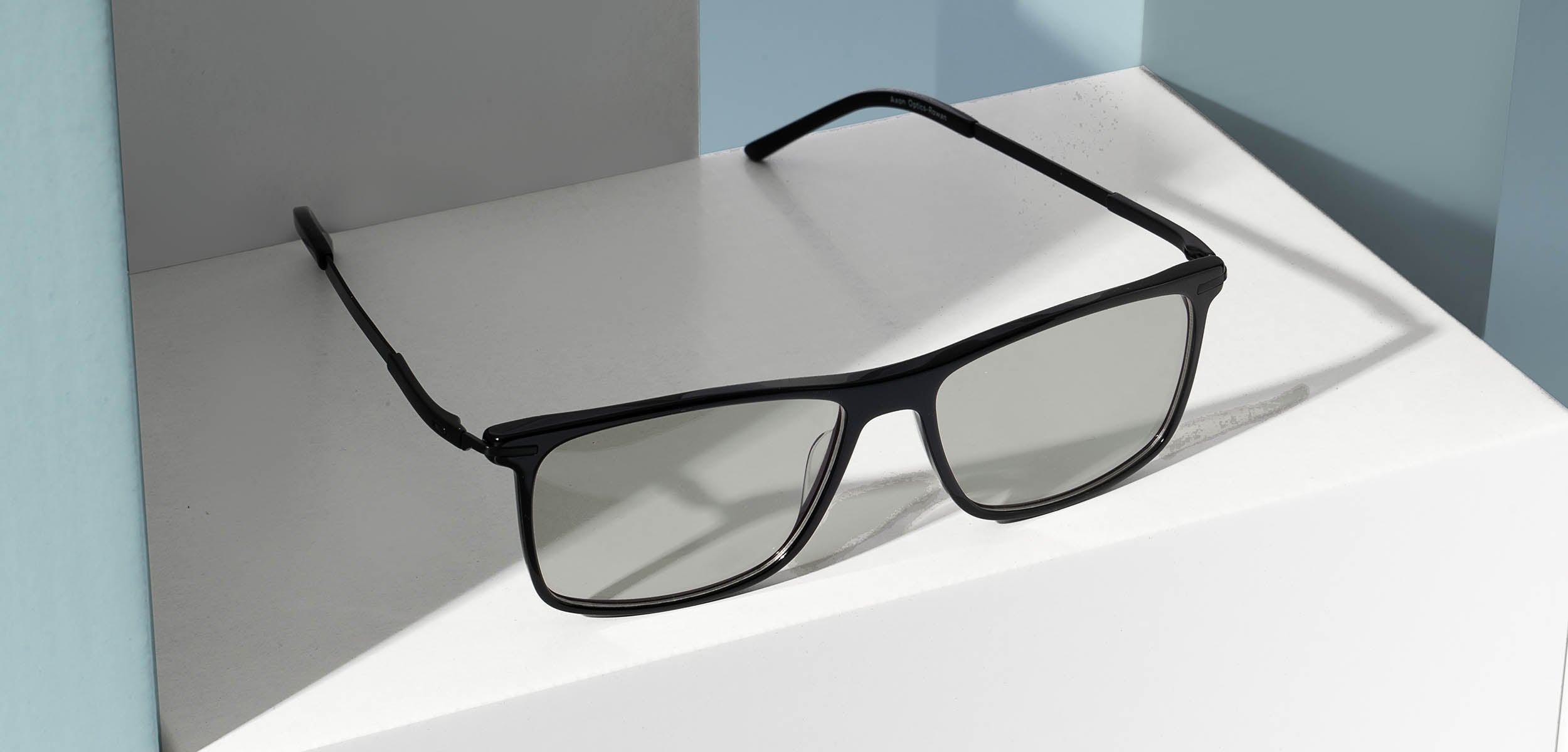 rowan migraine glasses placed on white block